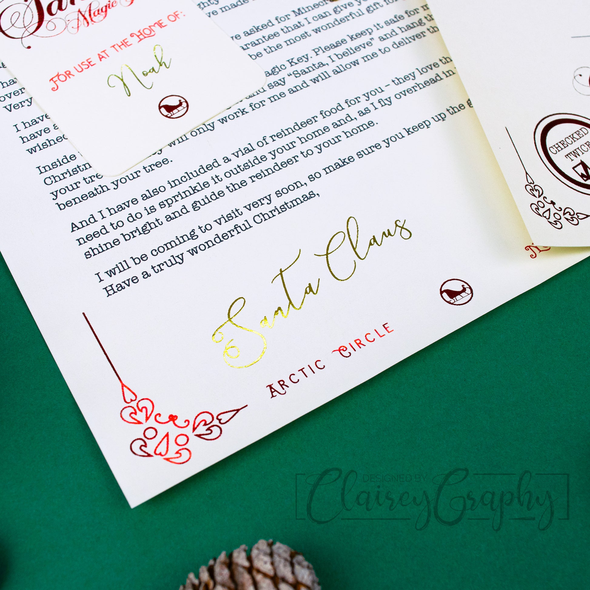 Personalised Letter from Santa. Close up of Santa's golden foiled signature.Printed on smooth ivory card stock and foiled in a stunning red and gold, each letter is personalised to the child/children.