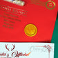 Close up of the golden seal on the red envelope. The seal features Santa's official reindeer symbol 