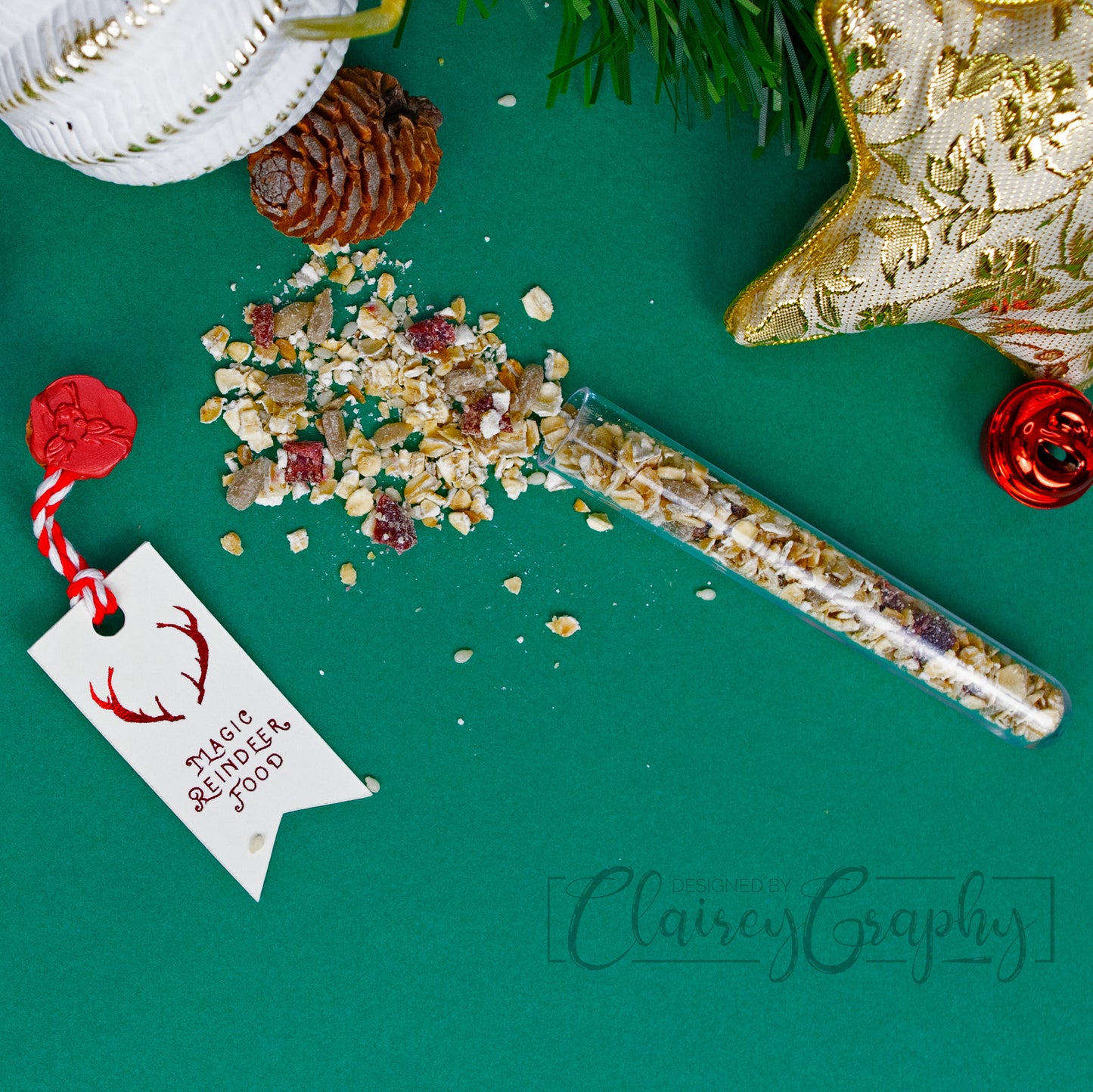 Santa's Magic Reindeer Food. The tag is printed on smooth ivory cardstock and foiled in bright red. The tag is then attached with red and white baker's twine to a plastic vial of RSPCA approved reindeer food. The vial is sealed with a wooden cork and the tag is attached with red wax.